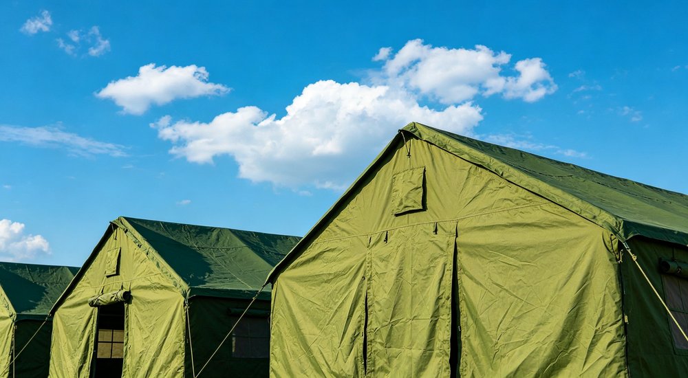 Emergency response tent captured during active deployment showing professional grade construction wind resistant frame and waterproof covering designed for long term use in challenging field conditions
