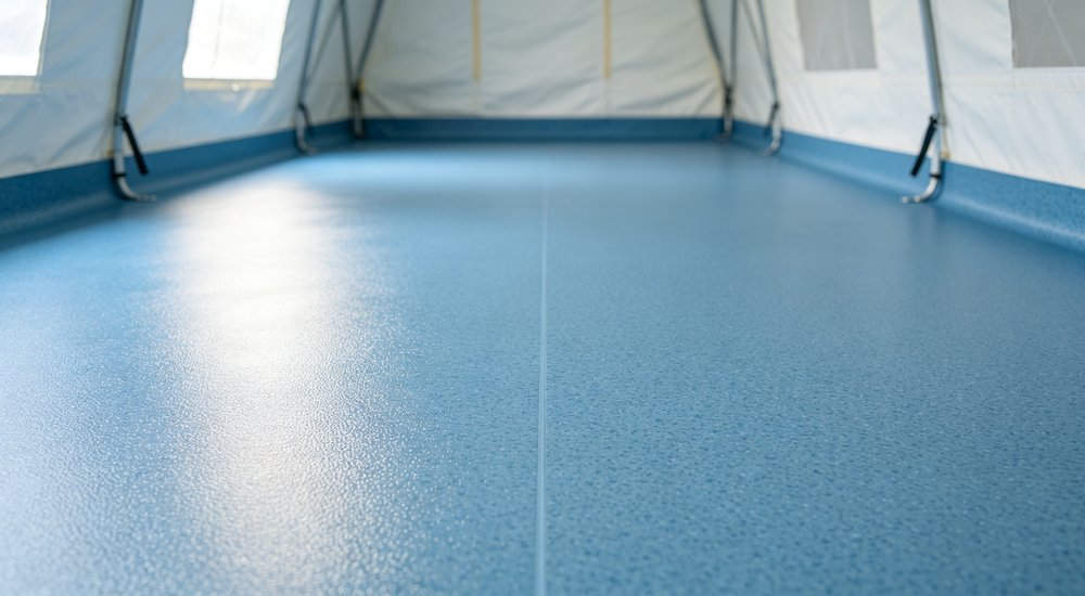 Medical grade floor of inflatable tent, easy clean PVC surface, close-up detail red and white inflatable emergency shelter for disaster relief operations