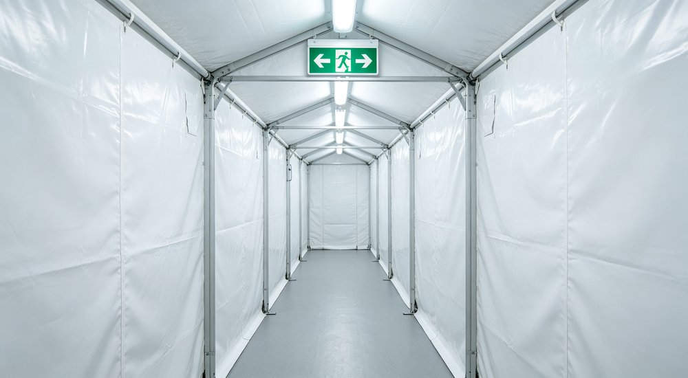 Emergency exit of inflatable medical tent, marked exit door, close-up detail red and white inflatable emergency shelter for disaster relief operations