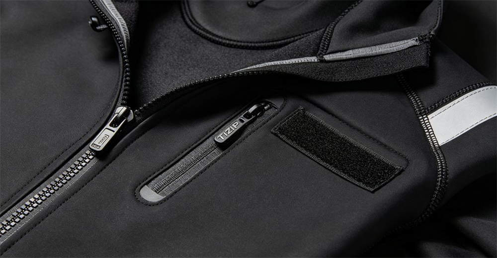 Close-up detail of professional dry suit showing waterproof zipper, sealed seams, and adjustable wrist and neck seals for water rescue Close-up detail of professional dry suit showing waterproof zipper, sealed seams, and adjustable wrist and neck seals for water rescue