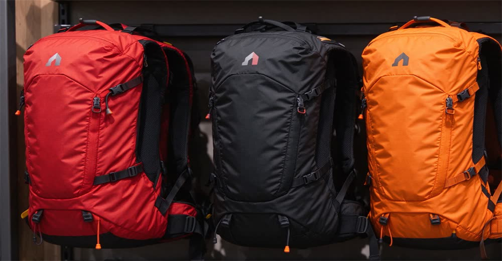 Front view of blue avalanche airbag backpack deployed showing large airbag system for backcountry skiers